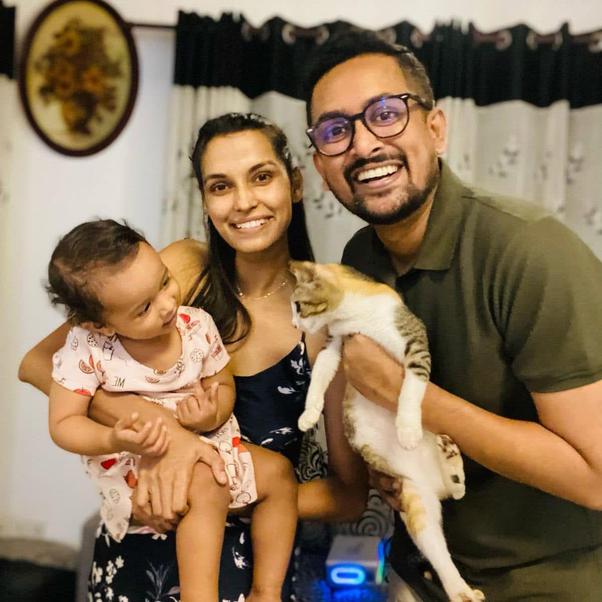 Founders of Sorted.lk, a young family in Negombo, with their child and cat.